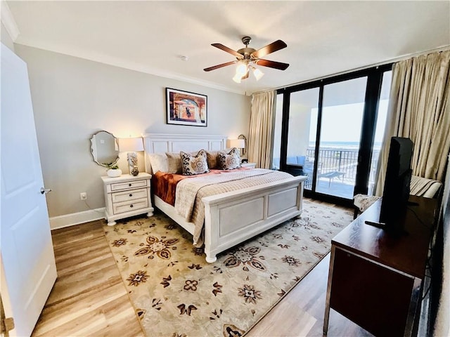 1601 Bienville Blvd Unit 316, Dauphin Island, AL 36528 - bedroom featuring access to outside, ceiling fan, light wood-style flooring, floor to ceiling windows, and baseboards