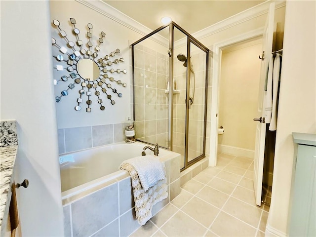 1601 Bienville Blvd Unit 316, Dauphin Island, AL 36528 - full bathroom with crown molding, tile patterned flooring, a stall shower, and a garden tub