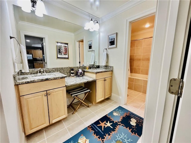 1601 Bienville Blvd Unit 316, Dauphin Island, AL 36528 - bathroom with ornamental molding, a sink, tile patterned floors, double vanity, and baseboards