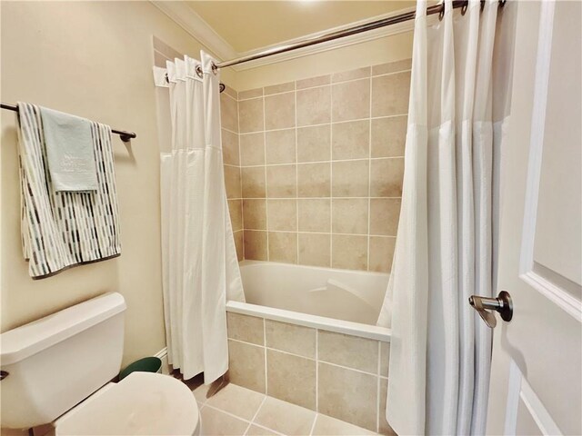 1601 Bienville Blvd Unit 316, Dauphin Island, AL 36528 - full bath with tile patterned floors, toilet, ornamental molding, and tiled shower / bath combo