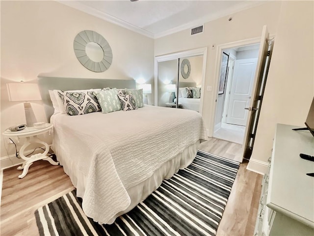 1601 Bienville Blvd Unit 316, Dauphin Island, AL 36528 - bedroom featuring light wood finished floors, visible vents, baseboards, and crown molding