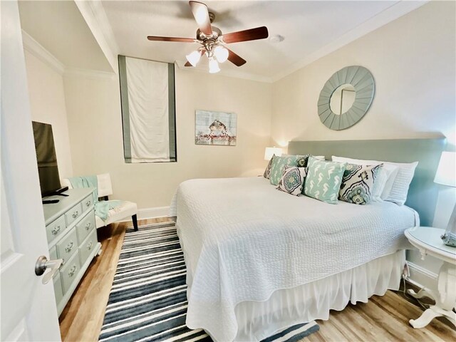 1601 Bienville Blvd Unit 316, Dauphin Island, AL 36528 - bedroom with ceiling fan, baseboards, crown molding, and wood finished floors