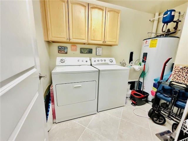 1601 Bienville Blvd Unit 316, Dauphin Island, AL 36528 - clothes washing area with water heater, cabinet space, separate washer and dryer, and light tile patterned flooring