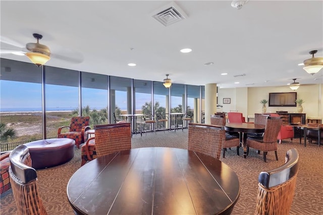 1601 Bienville Blvd Unit 316, Dauphin Island, AL 36528 - carpeted dining space featuring expansive windows, ceiling fan, visible vents, and recessed lighting