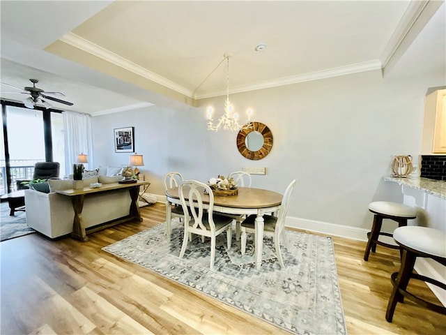 1601 Bienville Blvd Unit 316, Dauphin Island, AL 36528 - dining room with ornamental molding, baseboards, light wood-style floors, and ceiling fan with notable chandelier