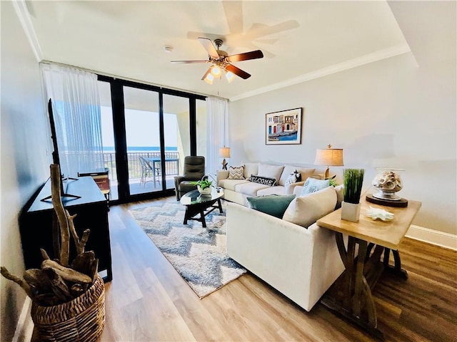 1601 Bienville Blvd Unit 316, Dauphin Island, AL 36528 - living room with baseboards, floor to ceiling windows, a ceiling fan, crown molding, and wood finished floors