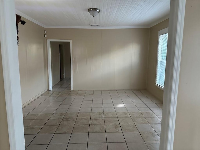 tiled empty room featuring ornamental molding