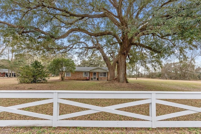 view of gate featuring fence and a lawn