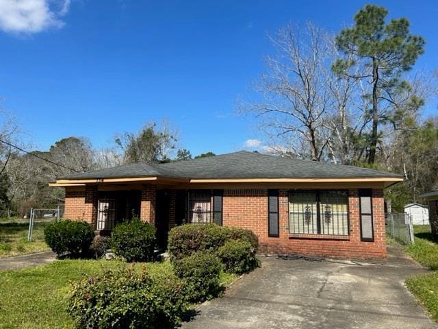 view of front of property with fence and brick siding