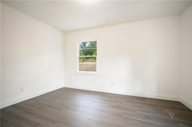 unfurnished room with dark hardwood / wood-style flooring