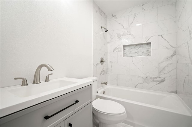 full bathroom featuring vanity, tiled shower / bath combo, and toilet