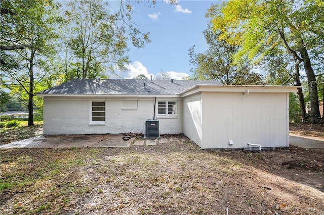 rear view of house with central AC and a patio area