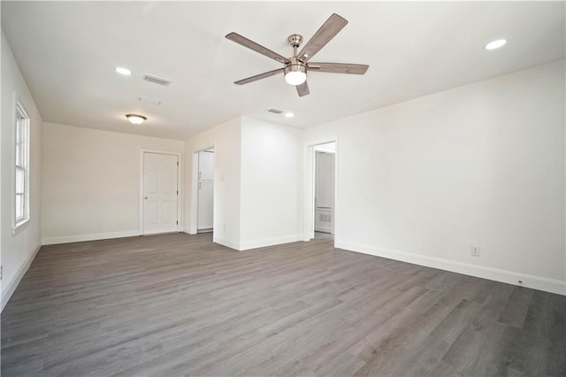 empty room with hardwood / wood-style floors and ceiling fan