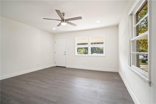 empty room featuring ceiling fan and dark hardwood / wood-style floors