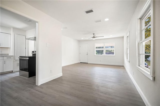 unfurnished living room featuring ceiling fan, plenty of natural light, and light hardwood / wood-style floors