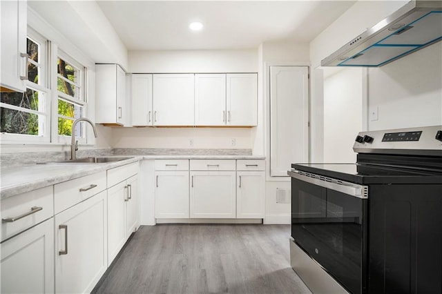 kitchen with sink, white cabinets, stainless steel electric range, and ventilation hood