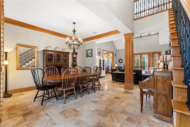 dining room featuring crown molding, french doors, a chandelier, and ornate columns