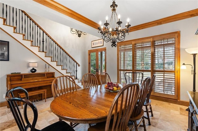 dining room featuring ornamental molding, an inviting chandelier, and french doors