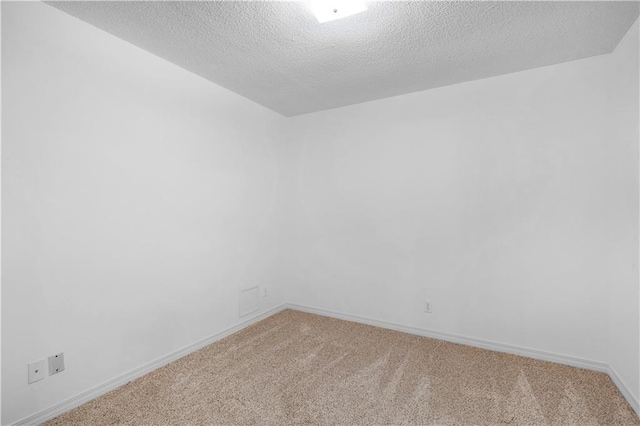 empty room featuring carpet flooring and a textured ceiling