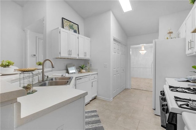 kitchen with white appliances, light tile patterned floors, sink, and white cabinets