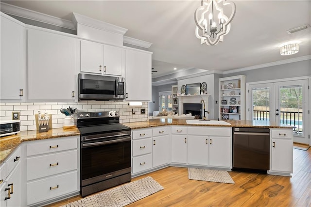 kitchen featuring range with electric cooktop, pendant lighting, white cabinetry, dishwasher, and sink