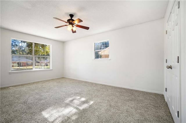 unfurnished room with carpet flooring and ceiling fan