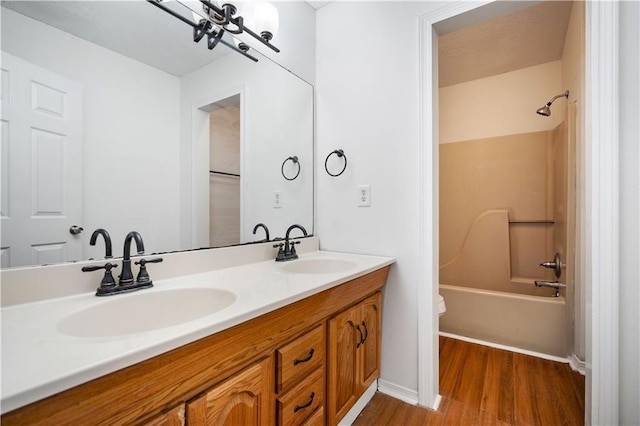 full bathroom featuring bathing tub / shower combination, vanity, wood-type flooring, and toilet