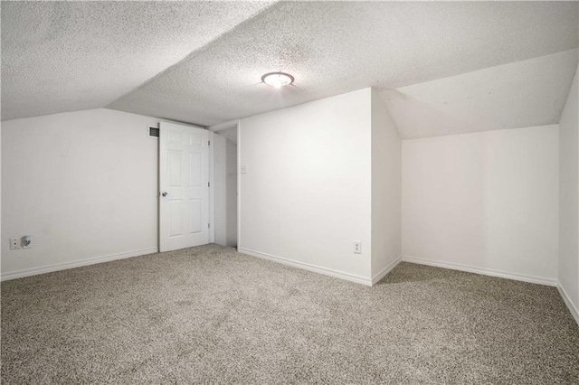 additional living space with a textured ceiling, carpet floors, and lofted ceiling