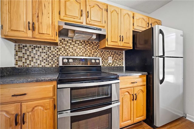 kitchen with decorative backsplash, hardwood / wood-style floors, and appliances with stainless steel finishes