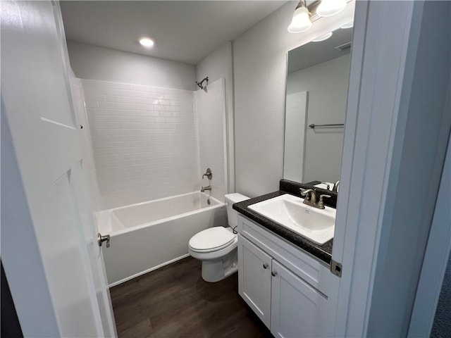 full bathroom featuring vanity, toilet, wood-type flooring, and tiled shower / bath combo