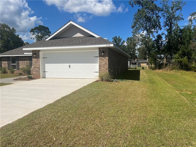 view of side of home with a garage and a yard