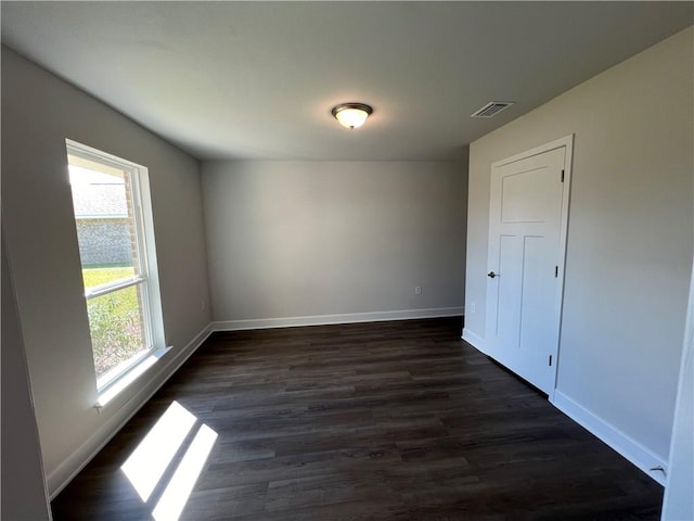 empty room with dark wood-type flooring