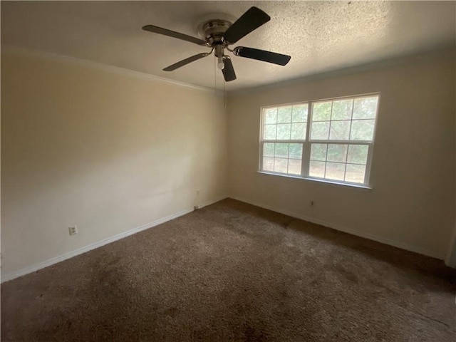 carpeted spare room with ceiling fan and a textured ceiling