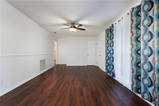 empty room featuring dark hardwood / wood-style floors and ceiling fan