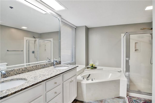 bathroom featuring independent shower and bath and vanity