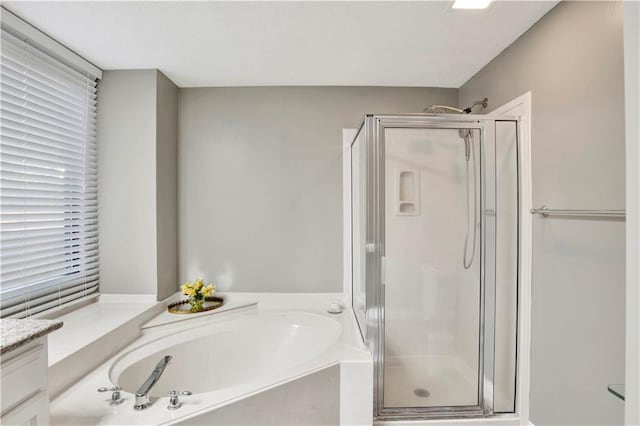 bathroom featuring vanity and plus walk in shower