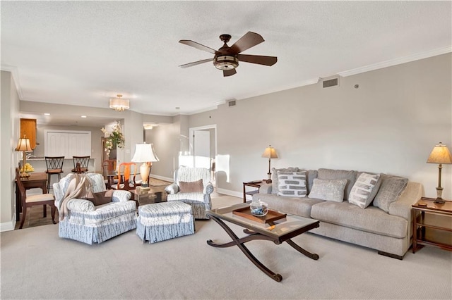 carpeted living room with ceiling fan and crown molding