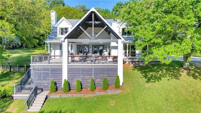 23749 Main St, Fairhope, AL 36532 - rear view of house with a chimney, a yard, and stairs