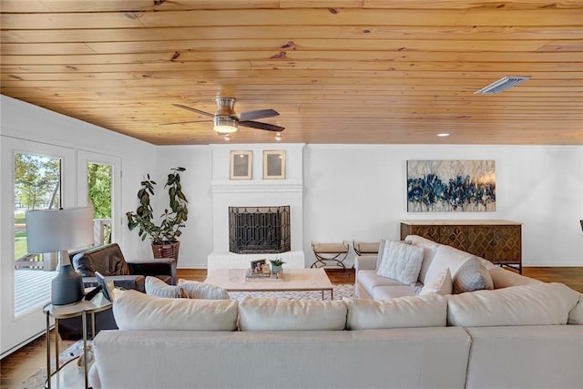 23749 Main St, Fairhope, AL 36532 - living area with wooden ceiling, ceiling fan, a brick fireplace, wood finished floors, and baseboards