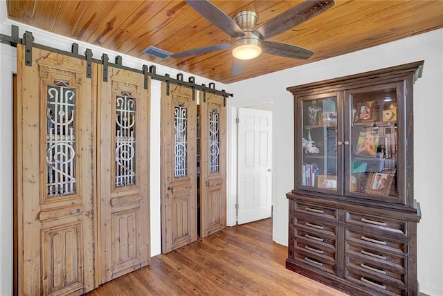 23749 Main St, Fairhope, AL 36532 - entryway featuring a barn door, ceiling fan, wooden ceiling, and wood finished floors