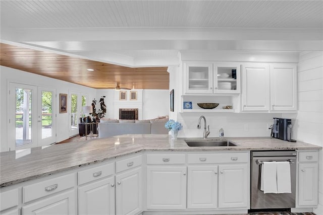 23749 Main St, Fairhope, AL 36532 - kitchen featuring dishwasher, a sink, white cabinetry, a fireplace, and light stone counters