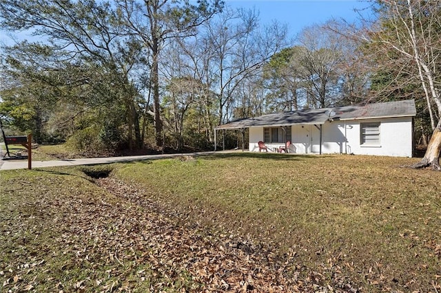 1208 Creekway Dr, Mobile, AL 36605 - view of green lawn featuring a carport