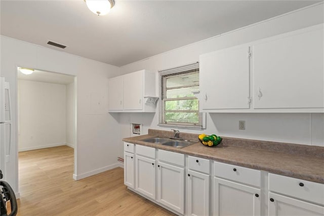 1208 Creekway Dr, Mobile, AL 36605 - kitchen with a sink, white cabinets, light wood-type flooring, and baseboards