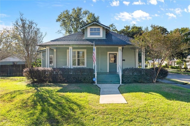 bungalow-style house featuring covered porch and a front lawn