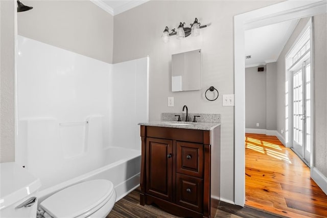 full bathroom featuring hardwood / wood-style floors, vanity, french doors, and toilet