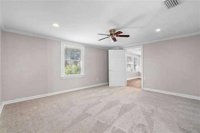 unfurnished bedroom featuring ceiling fan, light carpet, and ornamental molding