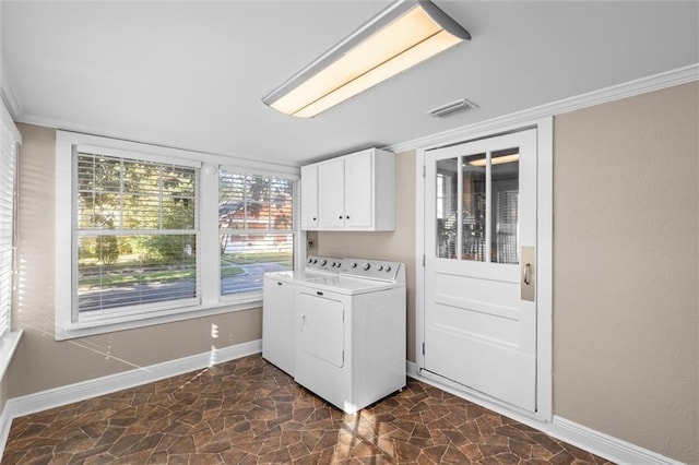 laundry area with cabinets, separate washer and dryer, and crown molding