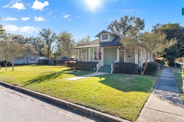 bungalow-style home with covered porch and a front yard