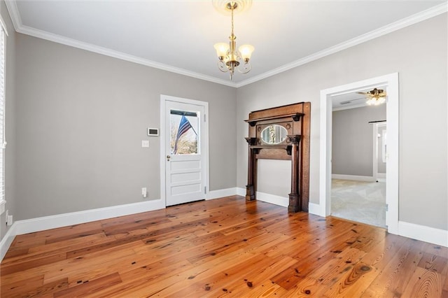 foyer featuring crown molding, ceiling fan with notable chandelier, and hardwood / wood-style flooring