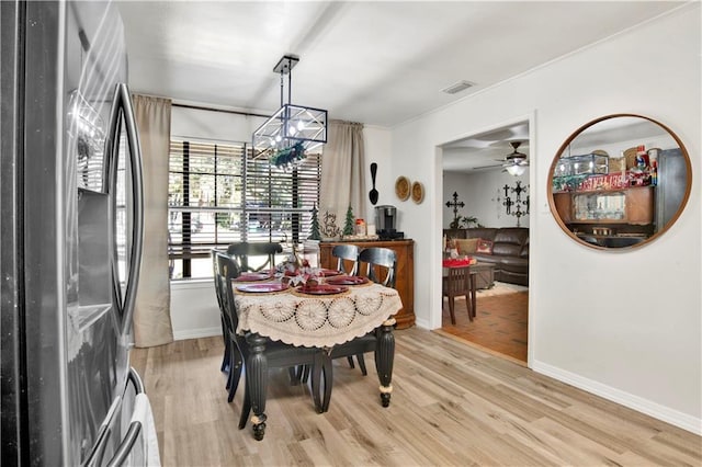 dining room featuring an inviting chandelier and light hardwood / wood-style flooring